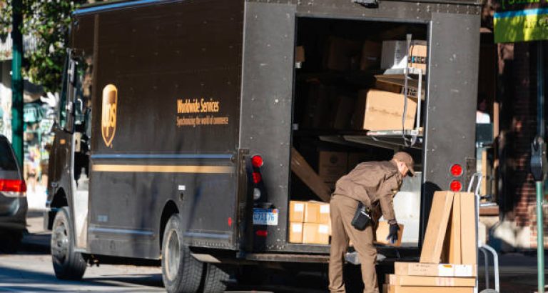 A UPS driver making deliveries in downtown Traverse City, Michigan. UPS is a package and letter delivery service with operations around the world.