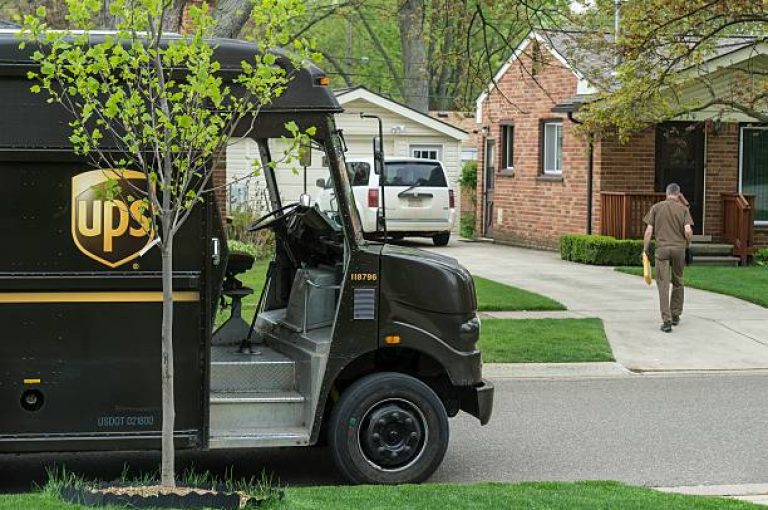 Rochester, Michigan, USA - May 11, 2016: A UPS driver making a delivery to a residence in Rochester.